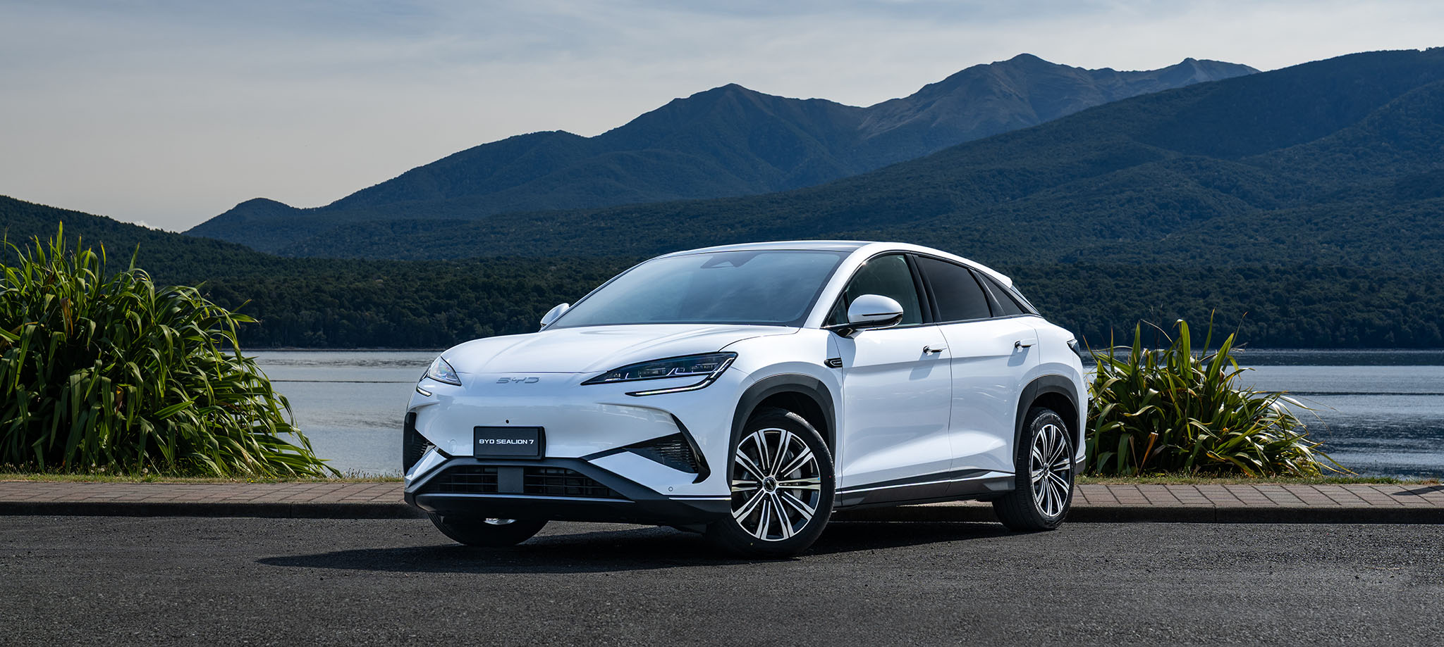 BYD Sealion 7 White parked in front of New Zealand lake