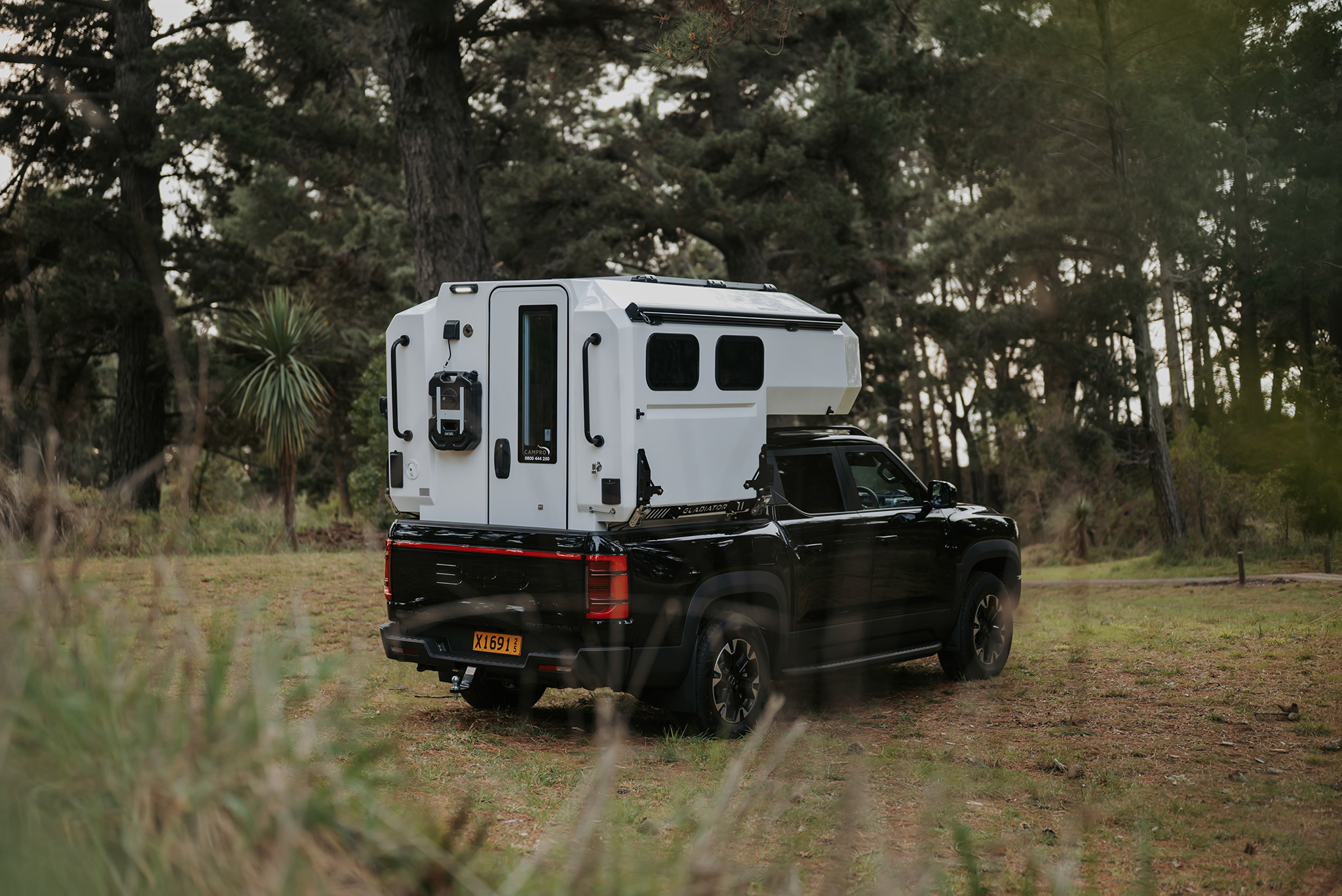 Campro Gladiator Pod on a black BYD Shark 6 at Rabbit Island forrest