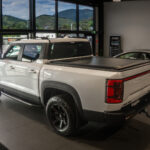 BYD Shark 6 White with Electric Sliding Tonneau Cover and Alloy Wheel Rims inside BYD Nelson Showroom