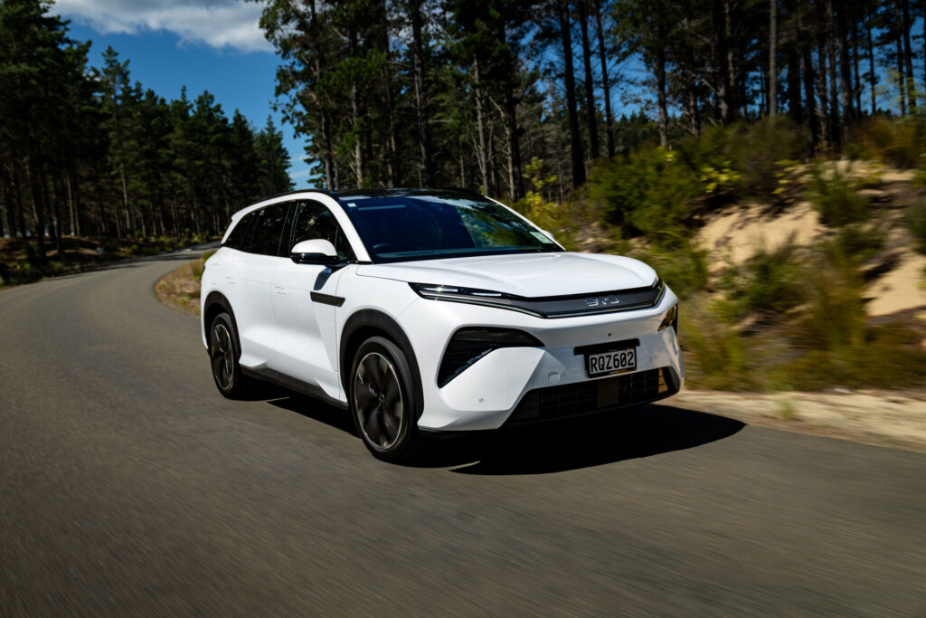 BYD Sealion 8 in white driving on New Zealand forest road