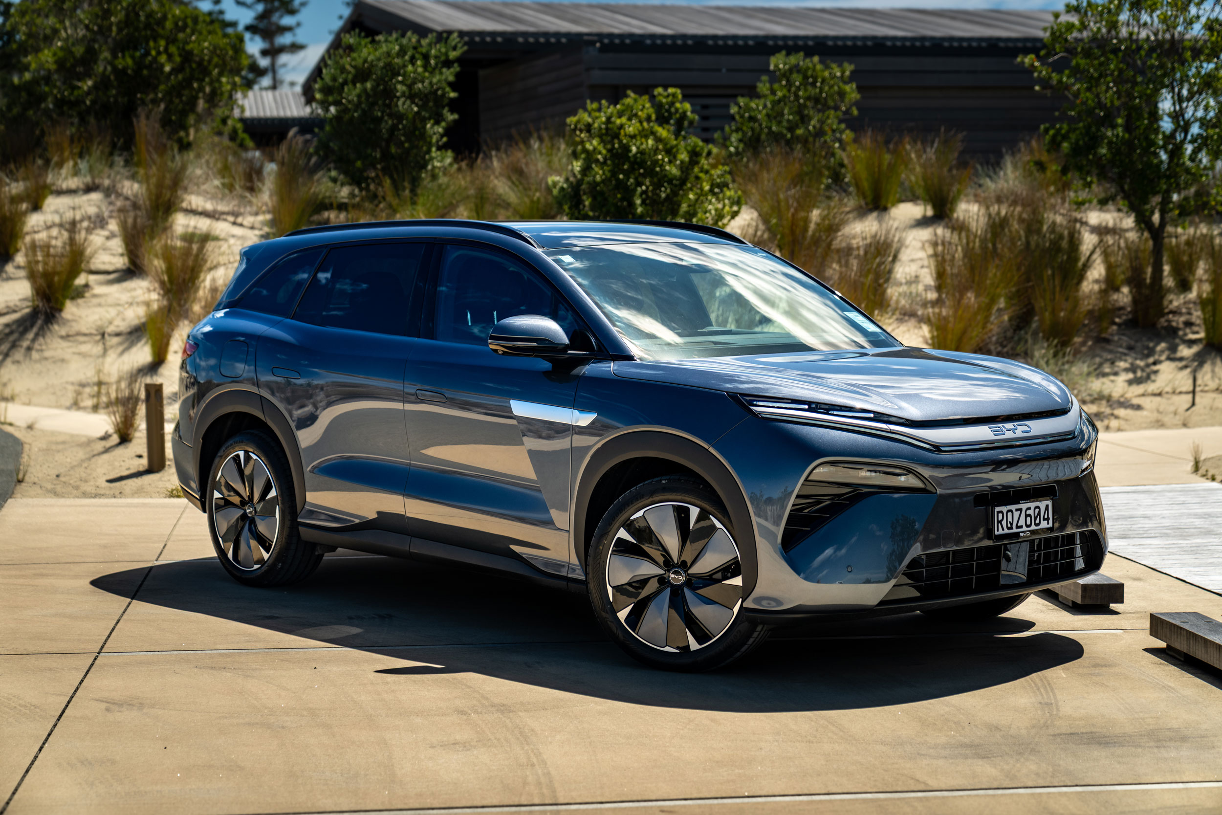 BYD SEALION 8 Premium Aquamarine colour parked in front of coastal grasses