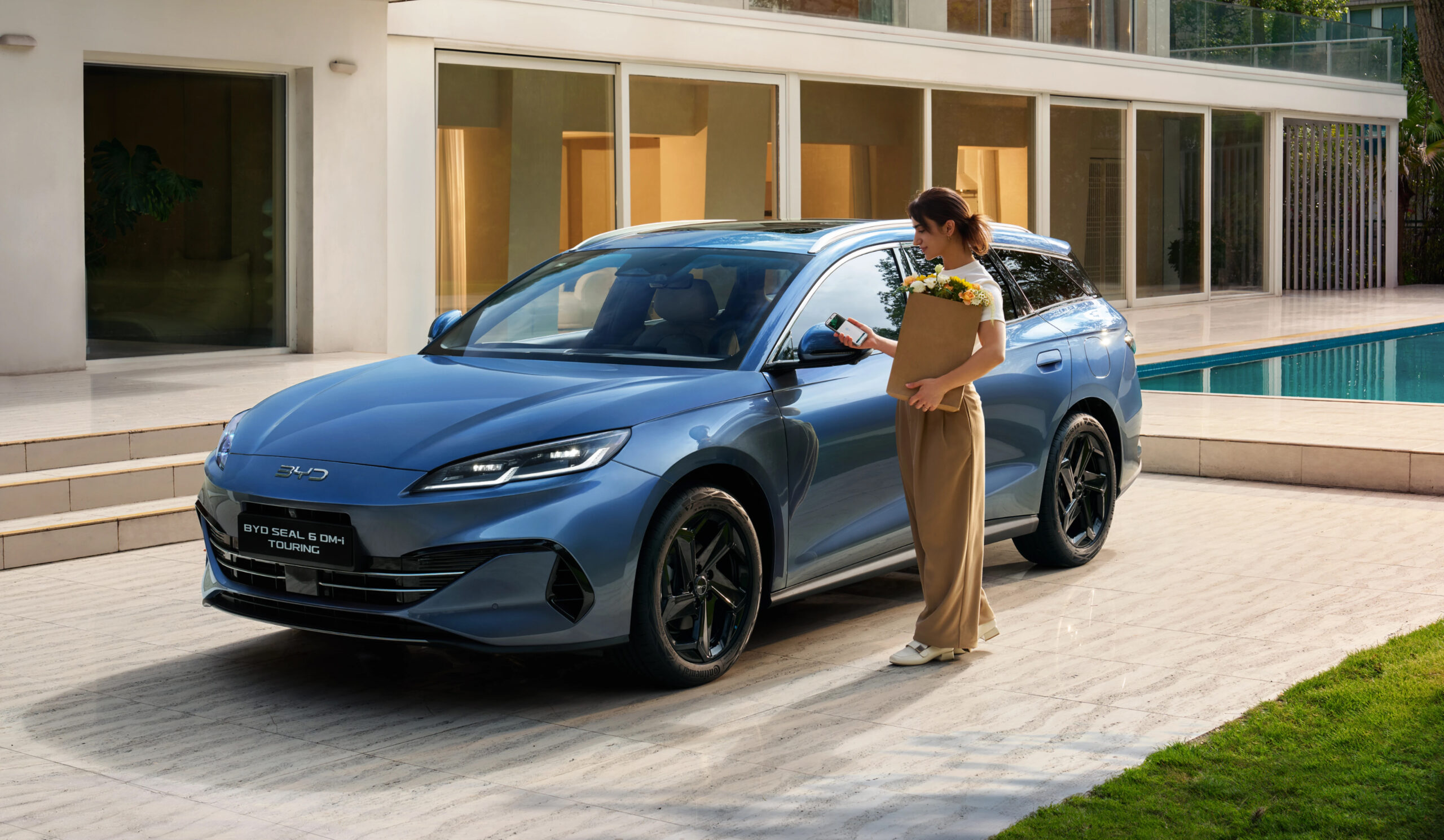 BYD Seal 6 Touring parked at home with woman using NFC card to unlock