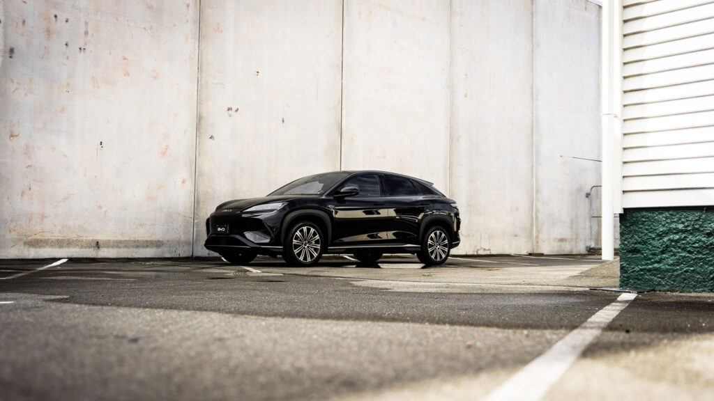 BYD Sealion 7 Premium EV black paint parked in front of concrete wall in car park.
