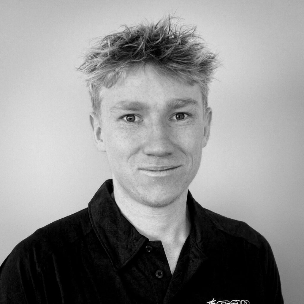 Finlay Wainwright - Sales Support BYD Nelson The Car Company. Black and White headshot, wearing black polo shirt.