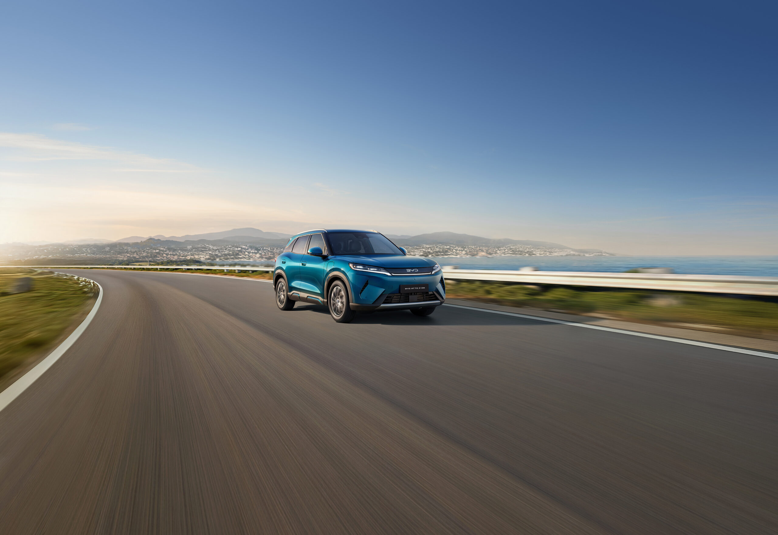 BYD Atto 2 DM-i Super Hybrid, driving on coastal road.
