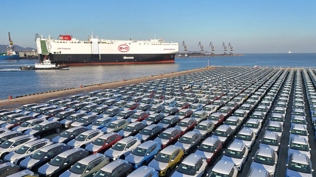 BYD shipping car carrier at port with hundreds of BYD cars parked waiting to be loaded