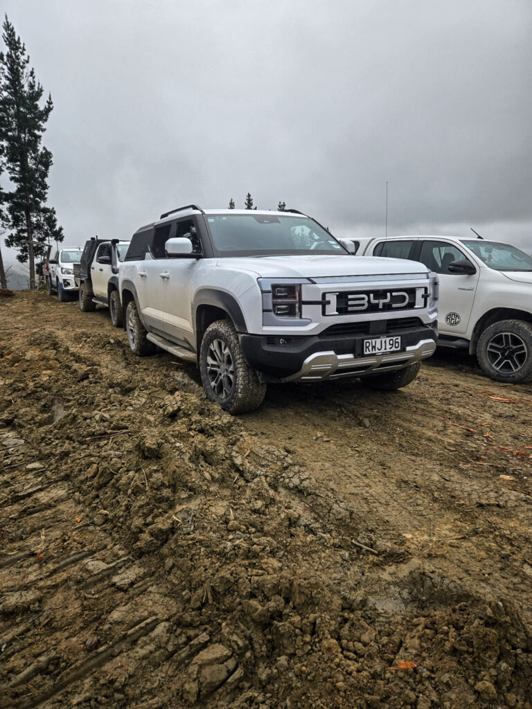 BYD Shark 6 parked in front of Toyota Hilux's, working in forestry