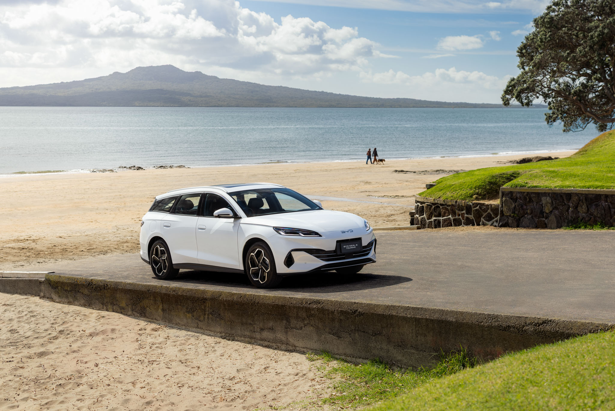 BYD Seal 6 Touring White, parked on boat ramp at New Zealand beach.
